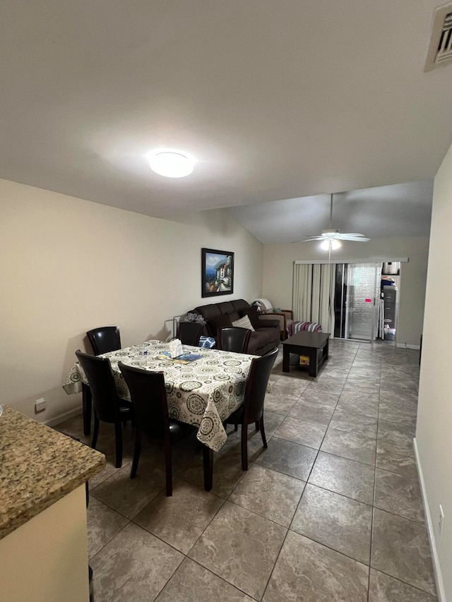 dining area featuring ceiling fan and vaulted ceiling