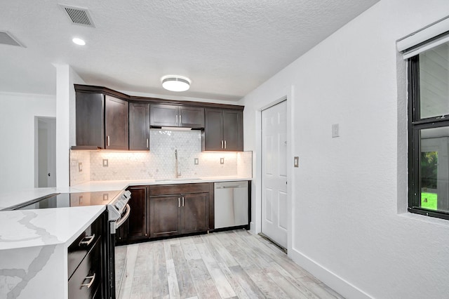 kitchen featuring light hardwood / wood-style flooring, sink, backsplash, dark brown cabinets, and appliances with stainless steel finishes