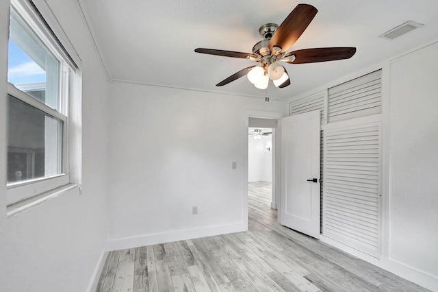 interior space with ornamental molding, light hardwood / wood-style floors, and ceiling fan