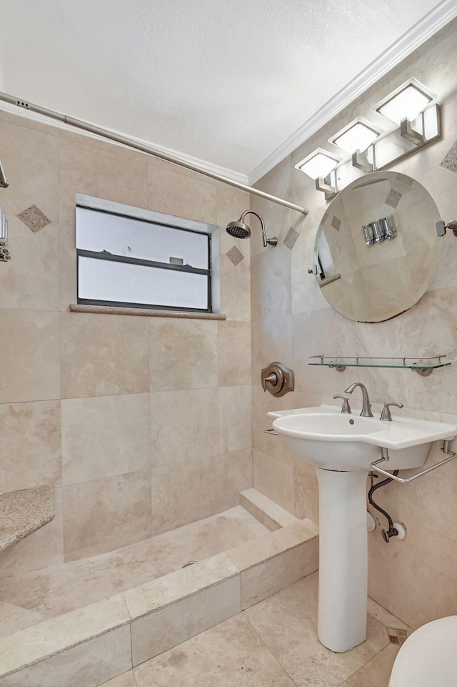 bathroom with tile walls, tile patterned flooring, a tile shower, and crown molding