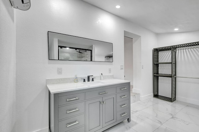 bathroom featuring a shower and vanity