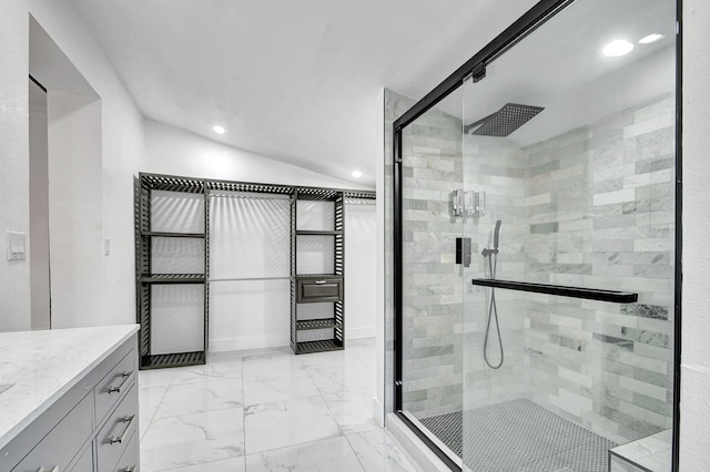 bathroom with walk in shower, vanity, and lofted ceiling