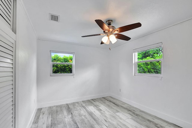 spare room with light hardwood / wood-style floors and ceiling fan