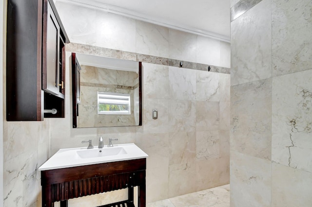 bathroom featuring vanity and tile walls