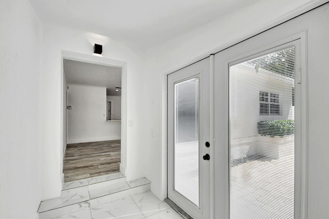 doorway to outside featuring french doors and light hardwood / wood-style flooring