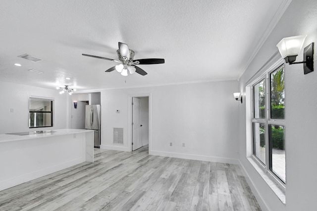 unfurnished living room with ceiling fan, a textured ceiling, light hardwood / wood-style flooring, and crown molding