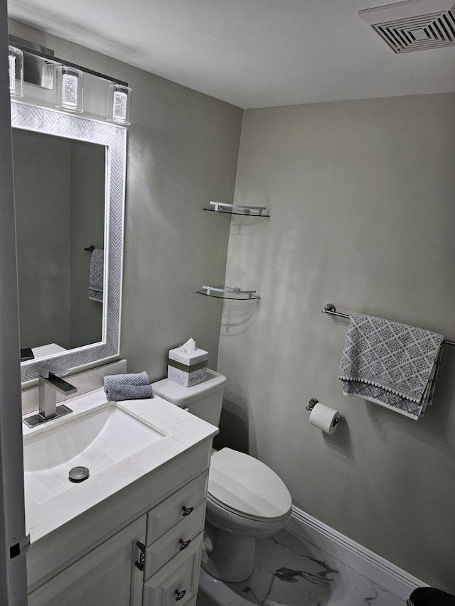 half bathroom with marble finish floor, visible vents, toilet, vanity, and baseboards