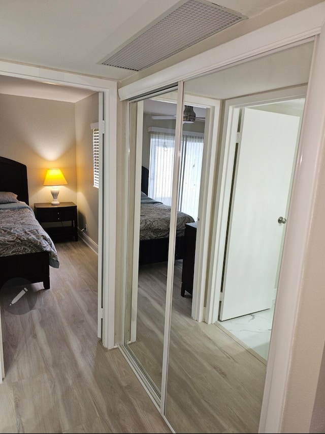 bedroom featuring wood finished floors and baseboards