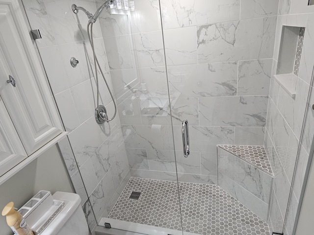 full bathroom with a shower stall and toilet