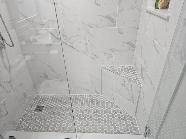 full bath featuring a tile shower