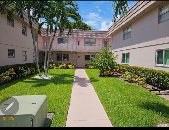 view of home's community with a lawn