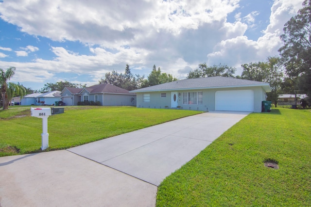 single story home featuring a garage and a front lawn