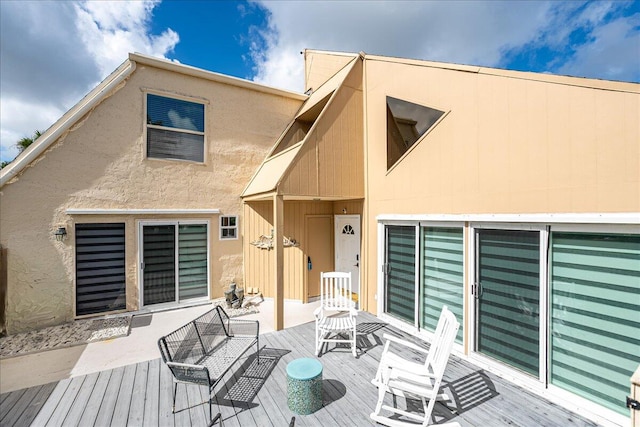 back of house featuring a wooden deck