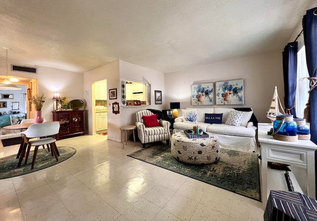 living room featuring a textured ceiling