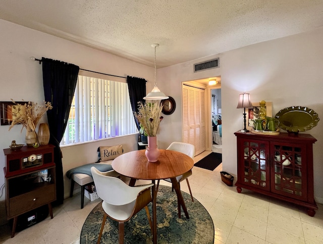 dining room with a textured ceiling