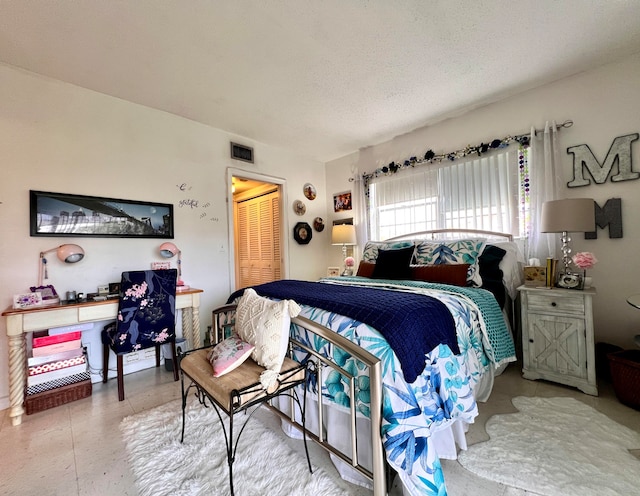 bedroom featuring a textured ceiling and a closet