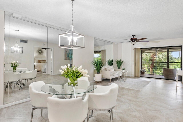 dining room featuring ceiling fan, a textured ceiling, and light tile patterned floors