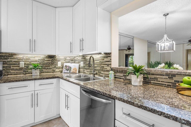 kitchen featuring dishwasher, a textured ceiling, sink, and white cabinets