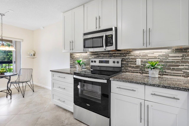 kitchen with decorative backsplash, white cabinets, a textured ceiling, and stainless steel appliances