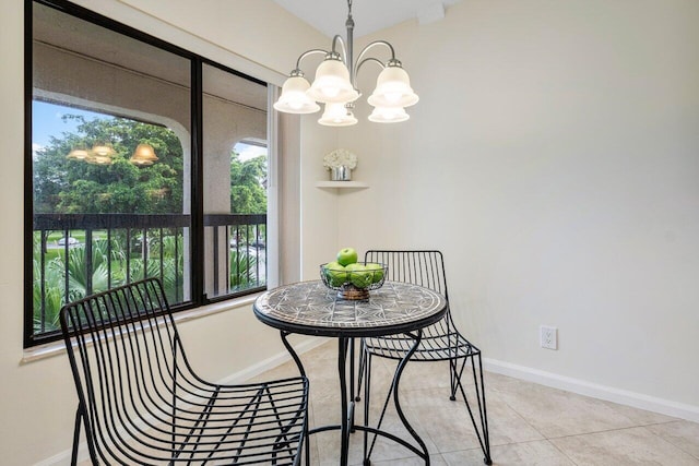 dining area with a chandelier and light tile patterned floors