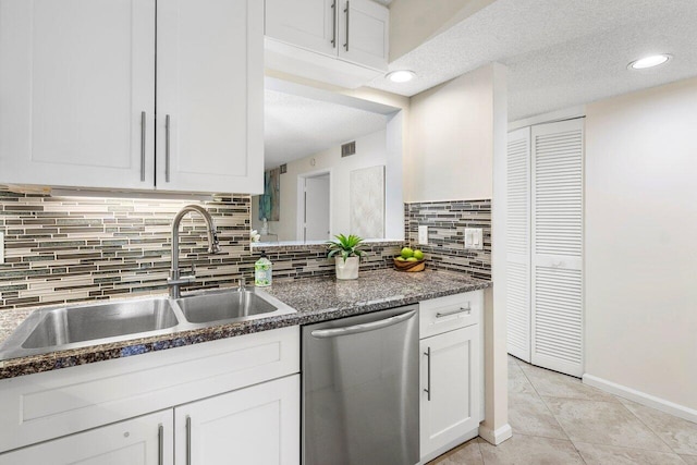 kitchen with decorative backsplash, stainless steel dishwasher, a textured ceiling, and white cabinets