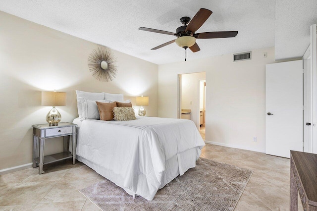 bedroom featuring a textured ceiling, light tile patterned floors, ceiling fan, and connected bathroom