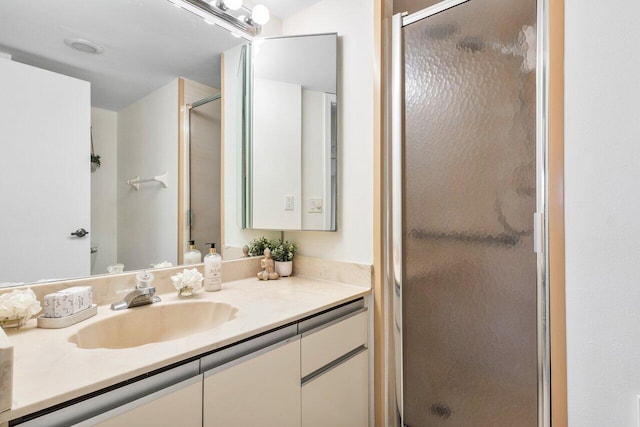 bathroom with vanity and a shower with shower door