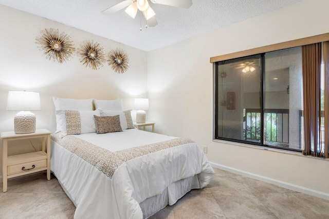 tiled bedroom with ceiling fan and a textured ceiling