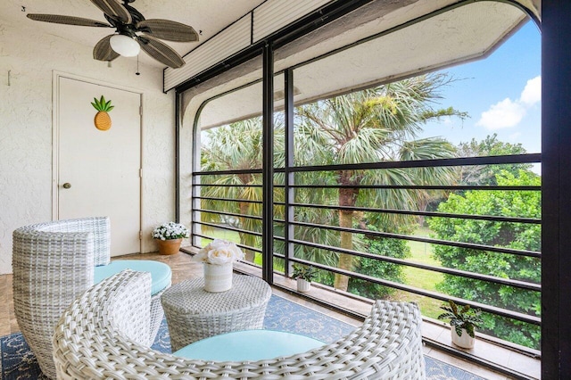 sunroom / solarium featuring ceiling fan