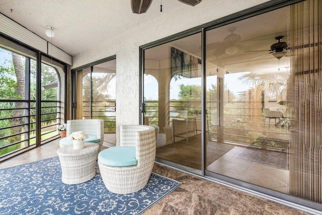 sunroom / solarium featuring ceiling fan