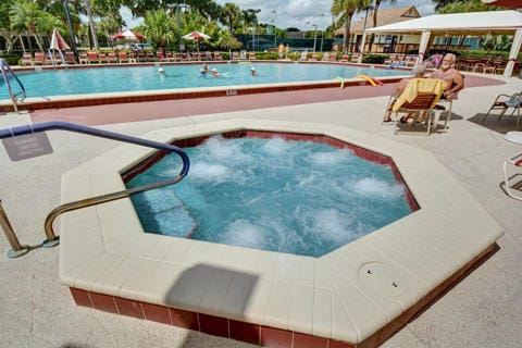 view of swimming pool with a patio area and a community hot tub