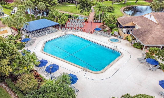 view of swimming pool with a gazebo, a water view, and a patio area