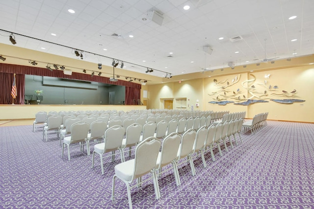 miscellaneous room featuring carpet and track lighting