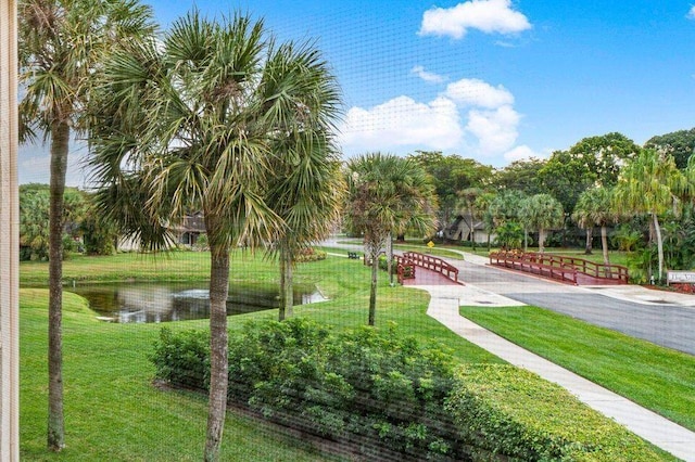 surrounding community featuring a water view and a yard