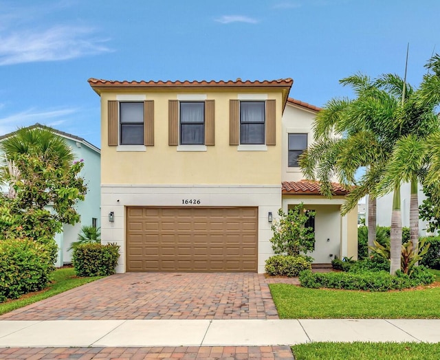 mediterranean / spanish-style house with a garage