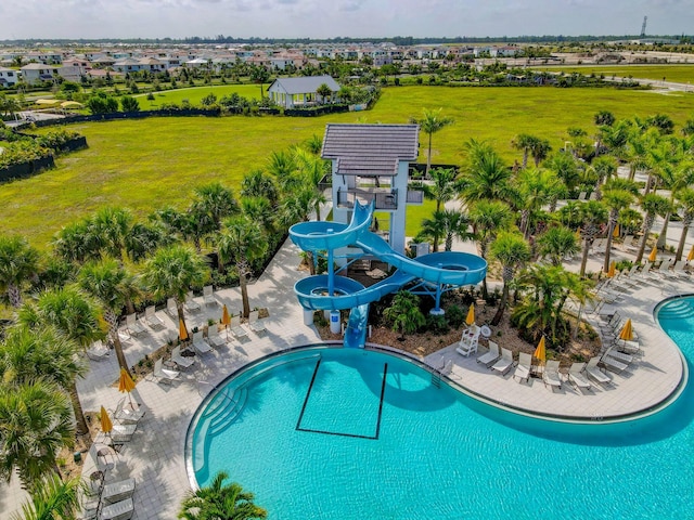 view of swimming pool featuring a water slide, a lawn, a gazebo, and a patio area