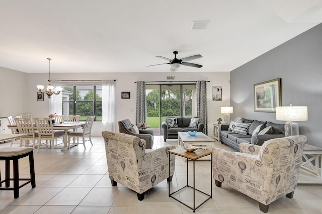 living room featuring ceiling fan with notable chandelier and light tile patterned floors