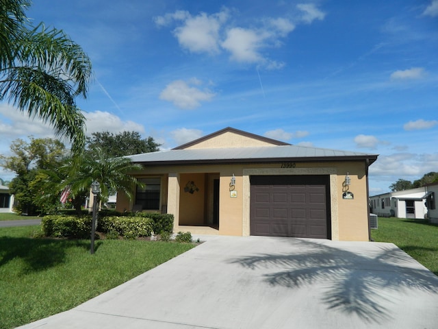 view of front of home featuring a front lawn, a garage, and central AC