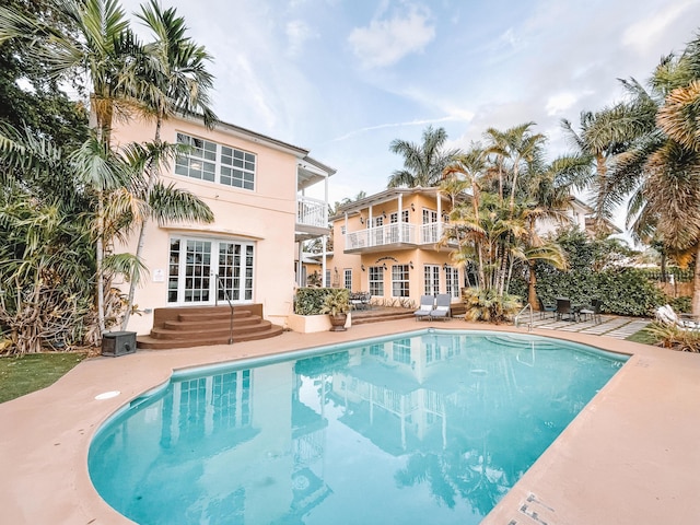 view of pool with a patio area and french doors