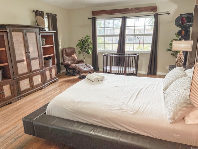 bedroom with hardwood / wood-style flooring