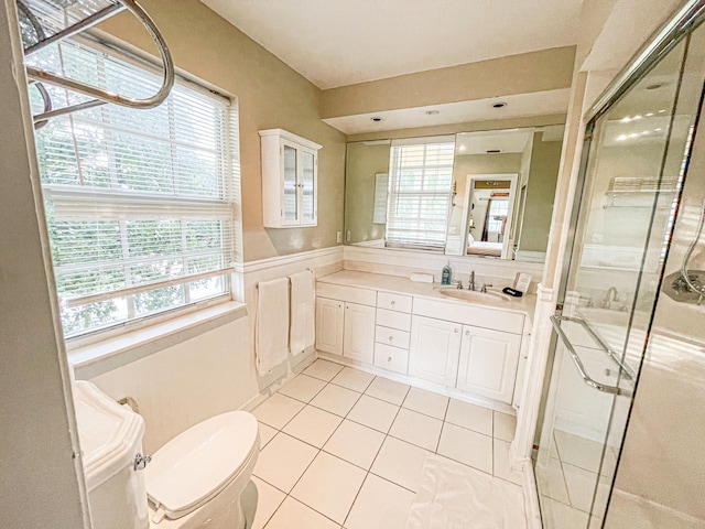 bathroom featuring vanity, an enclosed shower, and a wealth of natural light