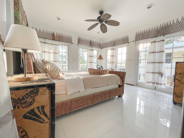 bedroom with access to outside, light tile patterned floors, and ceiling fan