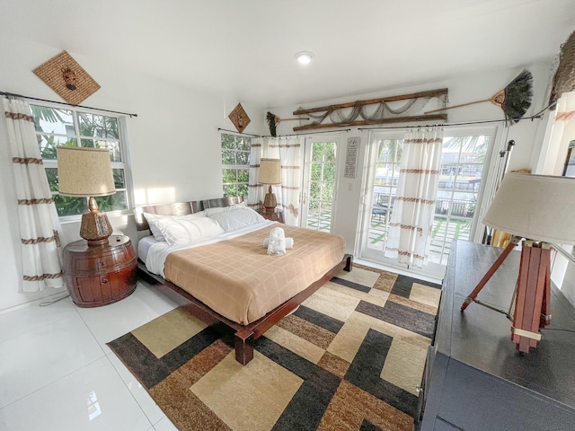 bedroom featuring access to outside and tile patterned floors