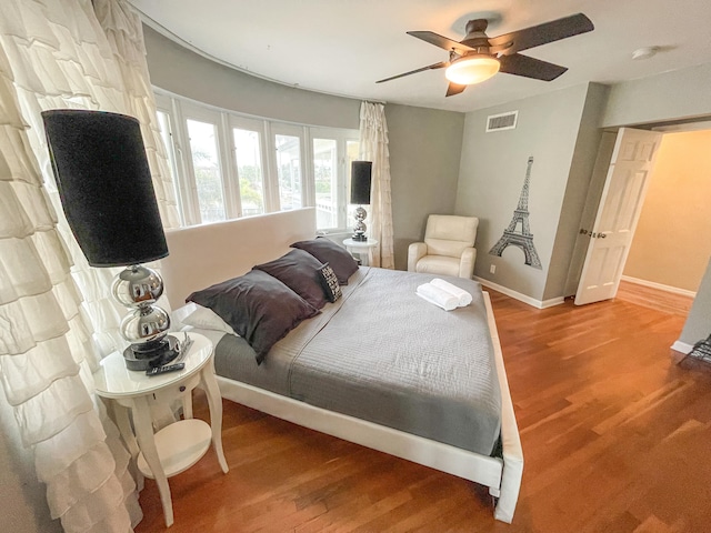 bedroom with hardwood / wood-style flooring and ceiling fan