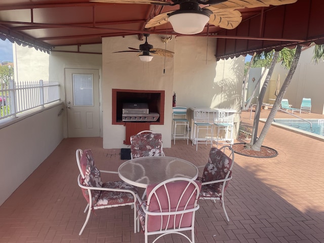 view of patio with area for grilling and a pool