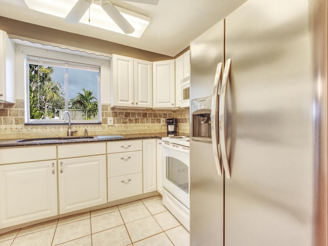 kitchen featuring white cabinetry, sink, light tile patterned floors, ceiling fan, and white appliances