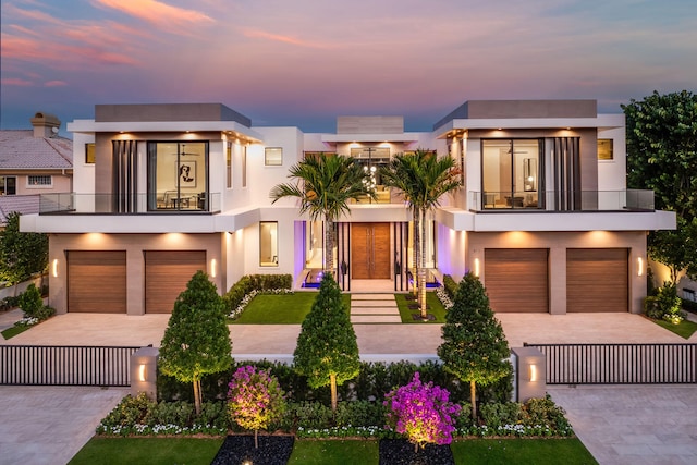 modern home featuring a garage and a balcony