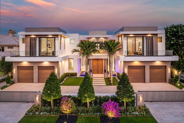 1520 Royal Palm Way, Boca Raton, FL 33432 - contemporary home featuring a balcony, an attached garage, stucco siding, and decorative driveway