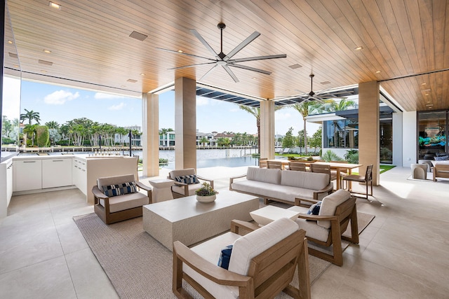 view of patio with an outdoor living space and a water view