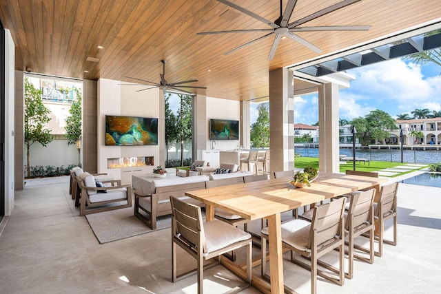 1520 Royal Palm Way, Boca Raton, FL 33432 - view of patio with exterior kitchen, a ceiling fan, an outdoor living space with a fireplace, and outdoor dining area